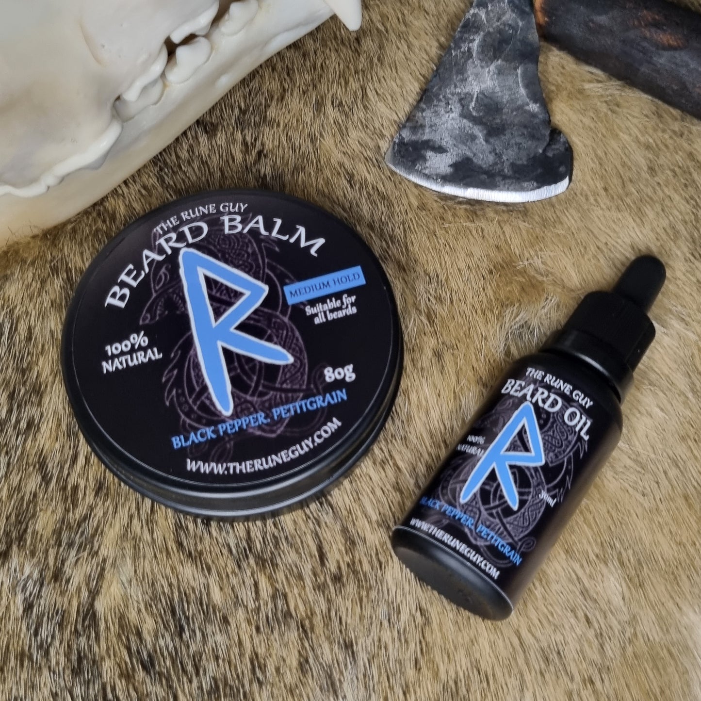 Beard balm and oil on a fur surface with a decorative axe.