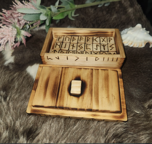 Wooden box with engraved symbols on a fur surface