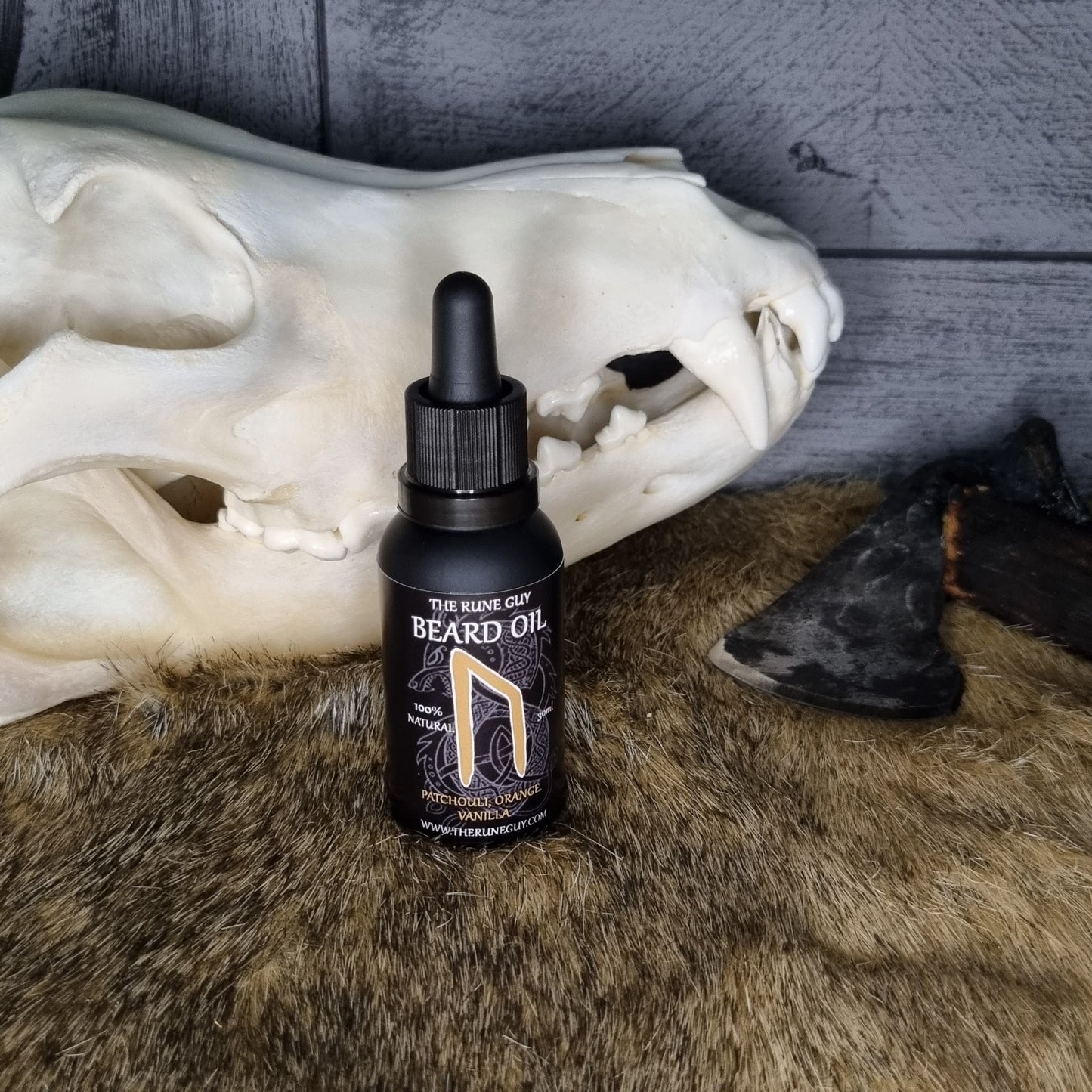 Beard oil bottle on a skull with fur background
