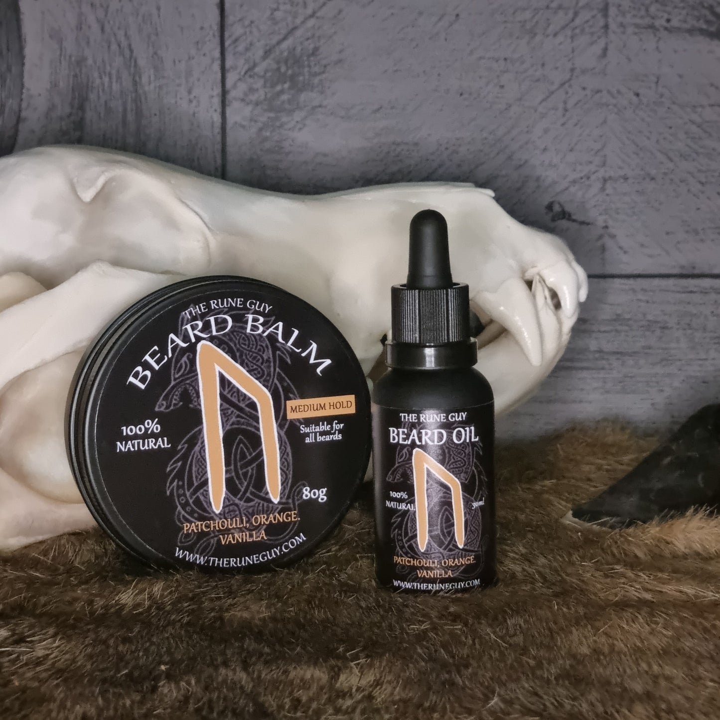 Beard care products including a balm and oil on a marble surface with a textured background.
