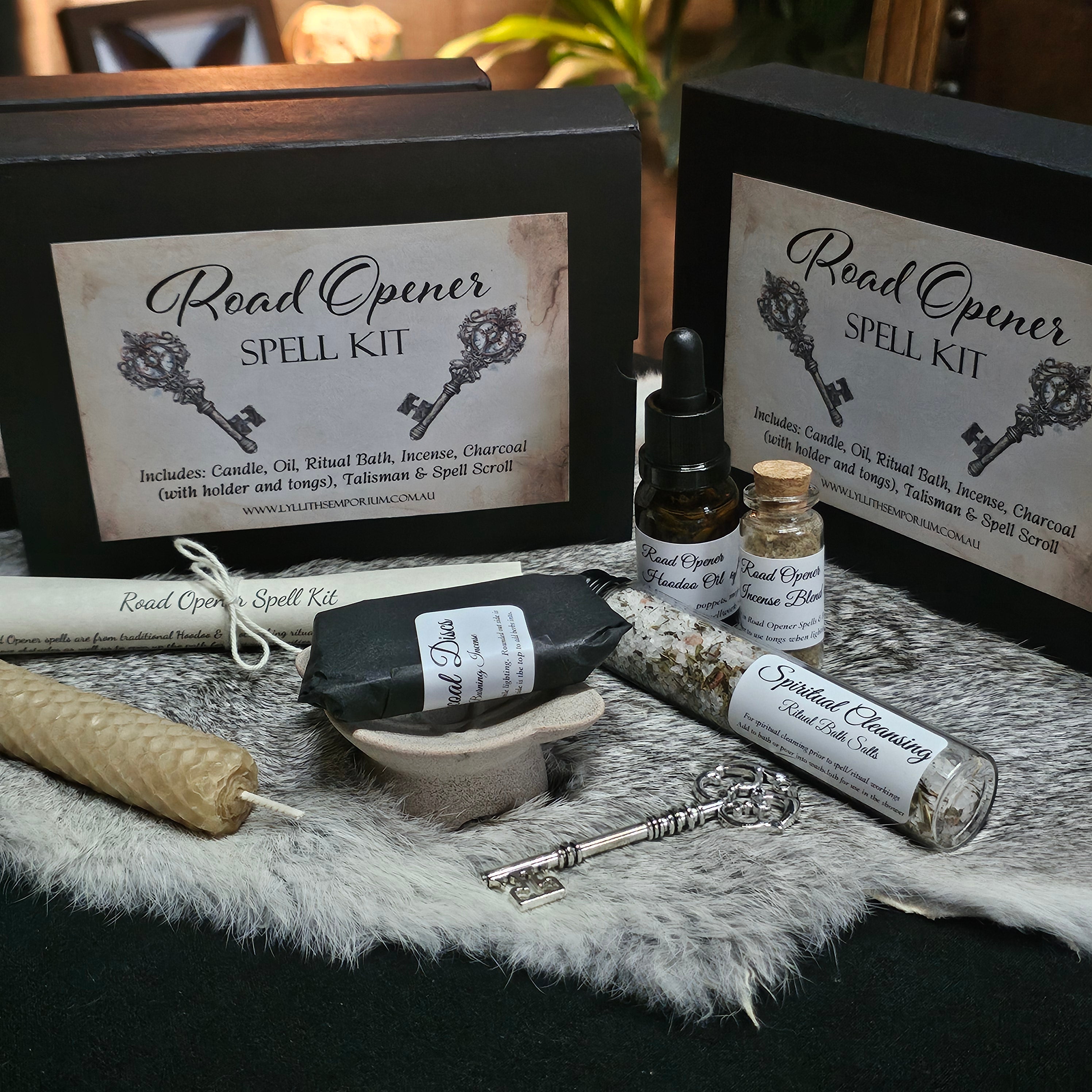 Road Opener Spell Kit with bottles, key, and candle on a textured surface