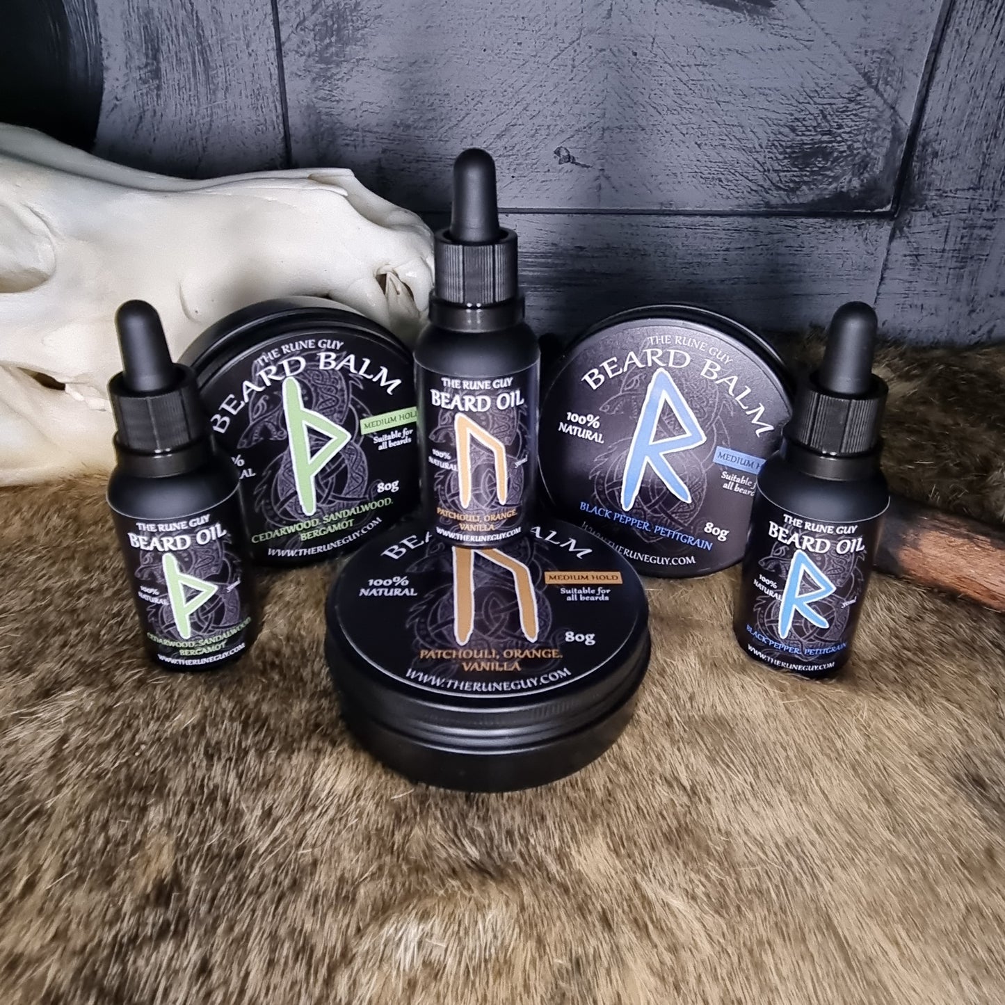 Collection of beard care products including balms and oils on a textured surface.