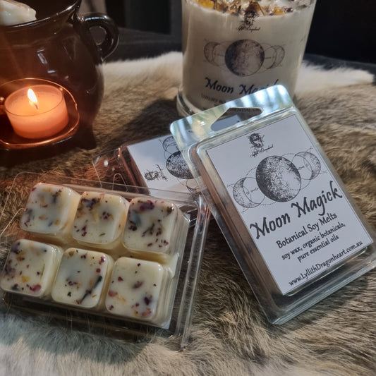 Packaged wax melts with a lit candle on a textured surface